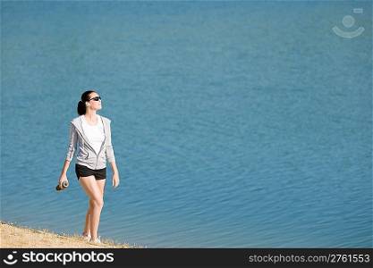 Summer beach active woman walk on beach in fitness outfit