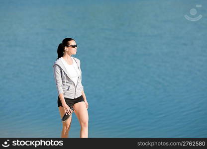 Summer beach active woman walk on beach in fitness outfit