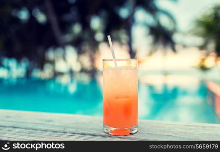 summer, beach, drink, cocktail and leisure concept - cocktail drink on tropical beach