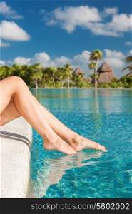 summer, beach, leisure and body part concept - closeup of woman legs at swimming pool