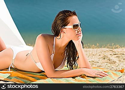 Summer beach stunning woman sunbathing in bikini parasol background