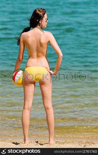 Summer beach topless woman enjoy sun hold ball