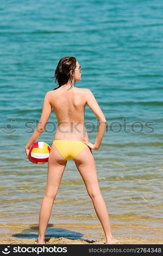 Summer beach topless woman enjoy sun hold ball