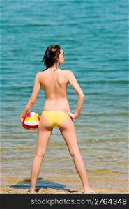 Summer beach topless woman enjoy sun hold ball