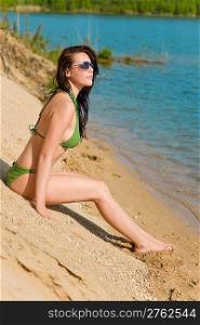 Summer beach young woman sunbathing in bikini alone