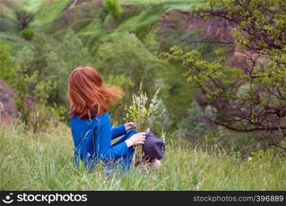 summer - beautiful girl on a meadow with a bouquet of wildflowers