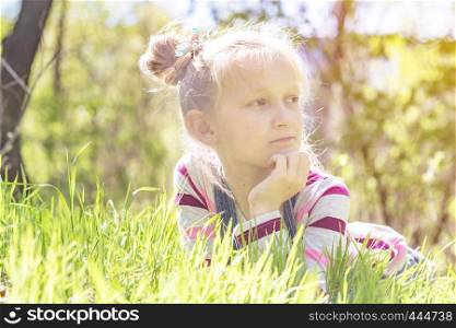 summer - beautiful little girl stands on a hillside meadow