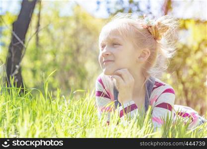 summer - beautiful little girl stands on a hillside meadow