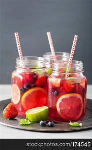 summer berry lemonade with lime and mint in mason jar