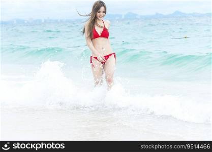 Summer bikini woman vacation on the tropical paradise beach. Cheerful woman wear red sexy bikini walking on beach. Time to relax in summer lifestyle outdoor shot on tropical island beach.