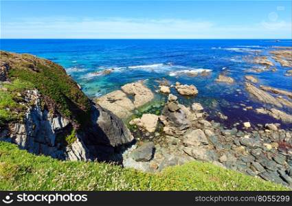 Summer blossoming Atlantic coastline landscape with white and pink flowers (near Los Castros beach, Galicia, Spain).