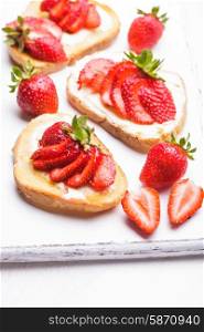 Summer breakfast - toasts with butter and strawberry. Summer breakfast