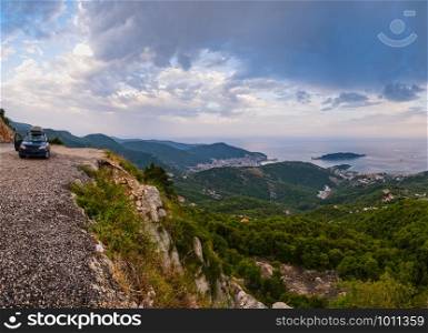 Summer Budva riviera coastline panorama landscape. Montenegro, Balkans, Adriatic sea, Europe. View from the top of the mountain road path. Car unrecognizable.