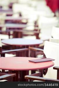 summer cafe table, shallow DOF, focus on menu