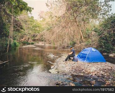 Summer camping near stream in tropical forest