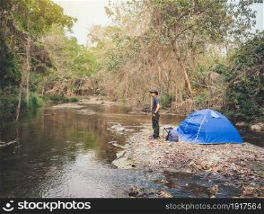 Summer camping near stream in tropical forest