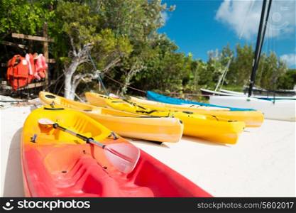summer, canoes, activities and vacations concept - canoes on sandy beach