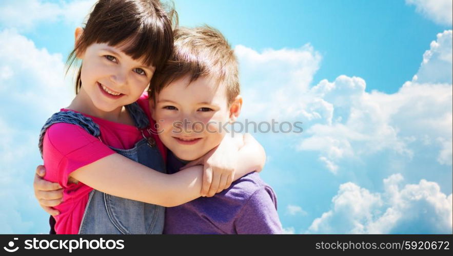 summer, childhood, family, friendship and people concept - two happy kids hugging over blue sky with clouds background