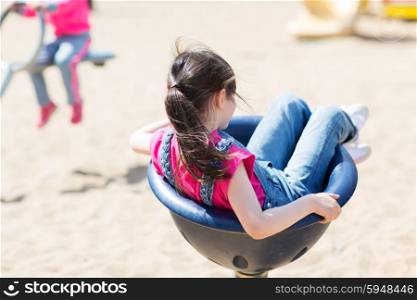 summer, childhood, leisure and people concept - close up of little girl playing on children playground