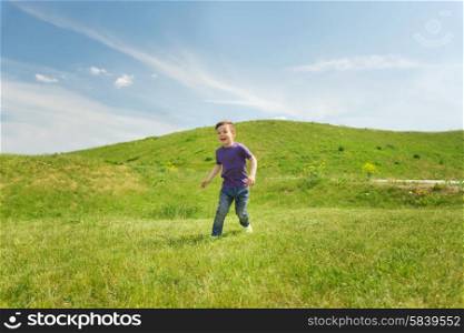 summer, childhood, leisure and people concept - happy little boy running on green field outdoors