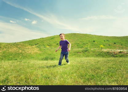 summer, childhood, leisure and people concept - happy little boy running on green field outdoors