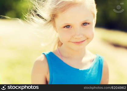 summer, childhood, leisure and people concept - happy little girl outdoors