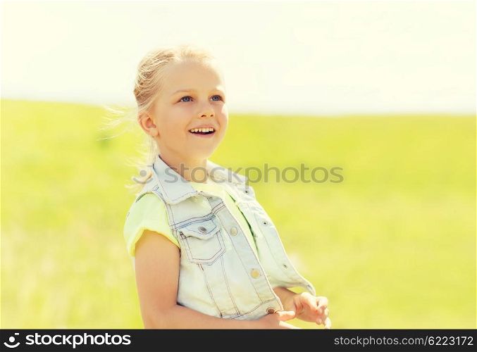 summer, childhood, leisure and people concept - happy little girl outdoors
