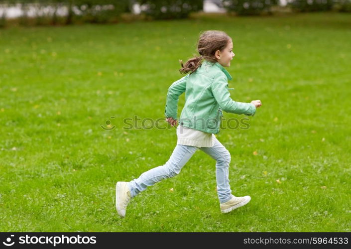 summer, childhood, leisure and people concept - happy little girl running on green summer field