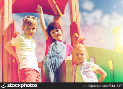 summer, childhood, leisure, friendship and people concept - group of happy kids on children playground. group of happy kids on children playground