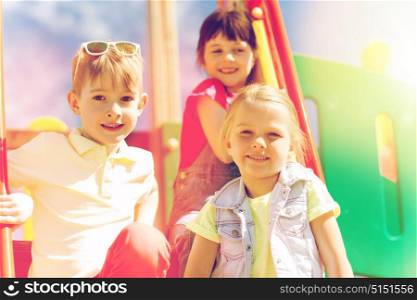 summer, childhood, leisure, friendship and people concept - group of happy kids on children playground. group of happy kids on children playground