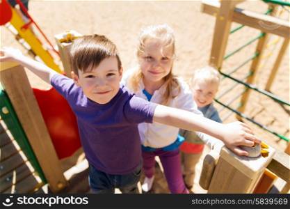 summer, childhood, leisure, friendship and people concept - group of happy kids on children playground