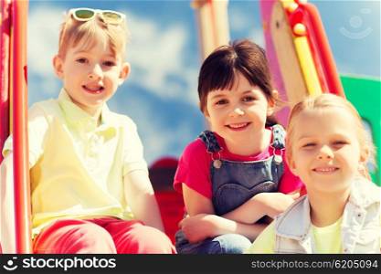 summer, childhood, leisure, friendship and people concept - group of happy kids on children playground
