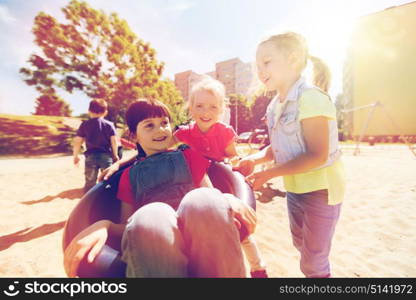 summer, childhood, leisure, friendship and people concept - happy kids on children playground climbing frame. happy kids on children playground