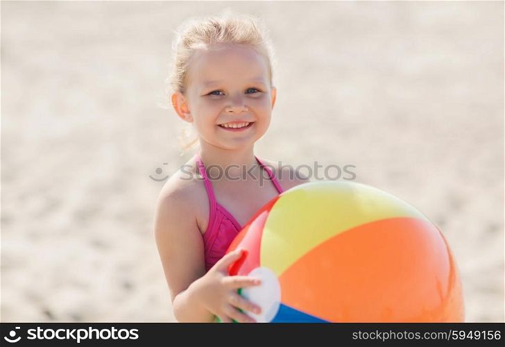 summer, childhood, vacation and people concept - happy little girl playing with inflatable ball on beach