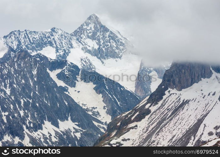 Summer cloudy Alps mountain and Bettmerhorn ridge view from Great Aletsch Glacier and ice fall (Bettmeralp, Switzerland)