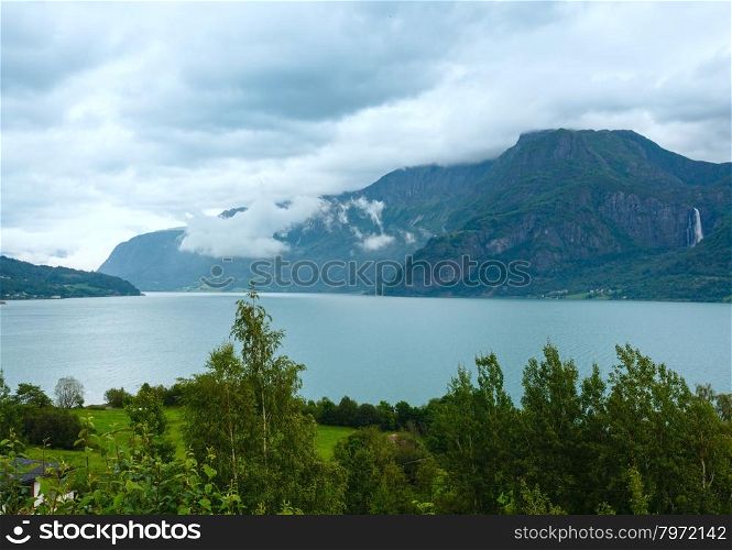 Summer cloudy mountain and fjord landscape (Norway).