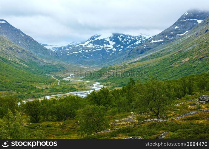 Summer cloudy mountain landscape with river (Norway).