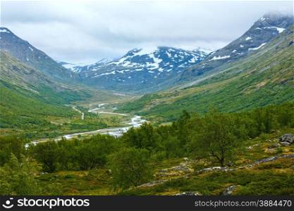 Summer cloudy mountain landscape with river (Norway).