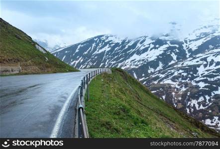 Summer cloudy mountain landscape with road (Oberalp Pass, Switzerland)