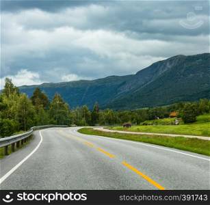 Summer cloudy mountain landscape with serpentine secondary road, Norway