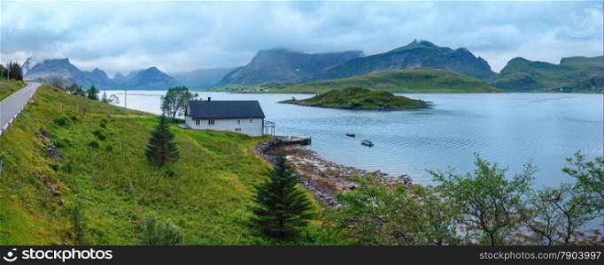 Summer cloudy sea coast panorama with road and house (Norway, Lofoten).