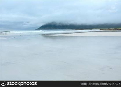 Summer cloudy view of the beach with white sand in Ramberg (Norway, Lofoten).
