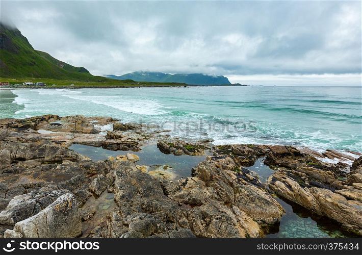 Summer cloudy view of the stony beach in Ramberg (Norway, Lofoten). People unrecognizable.
