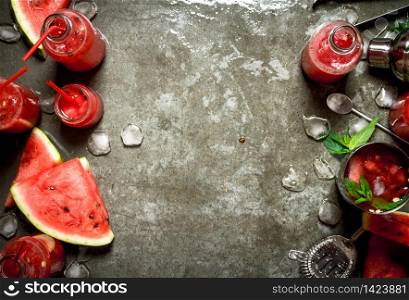 Summer cocktail. Watermelon slices with mint and ice in a shaker. On the stone table.. Watermelon chocktail with mint