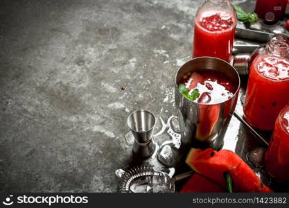 Summer cocktail. Watermelon slices with mint and ice in a shaker. On the stone table.. Watermelon chocktail with mint