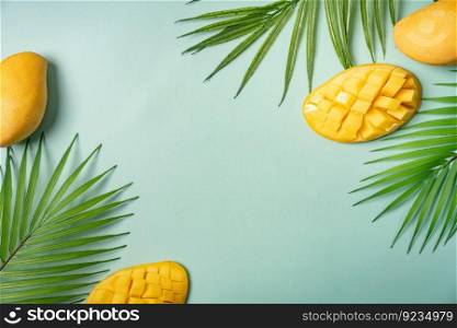 Summer colorfull concept with tropical fruits and leaves on green background, flat lay, top view, copy space. Summer colorfull background