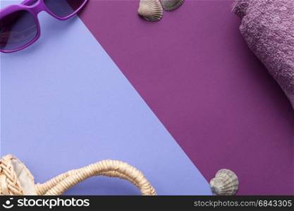 Summer concept. Beach accessories on purple background. Flat lay. Minimal style. Copy space. Top view.