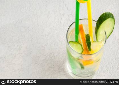 summer cooling drink with lemon and cucumber in a glass. fresh beverage in a glass
