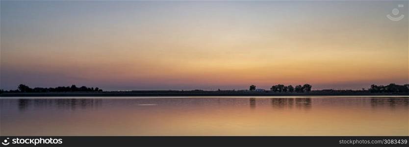 summer dawn over a calm lake - Boyd Lake State Park, popular boating and recreation area in northern Colorado