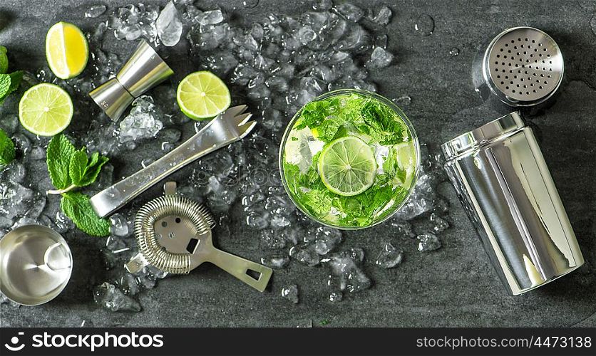 Summer drink mojito with lime, mint and ice. Top view. Glass of cocktail.